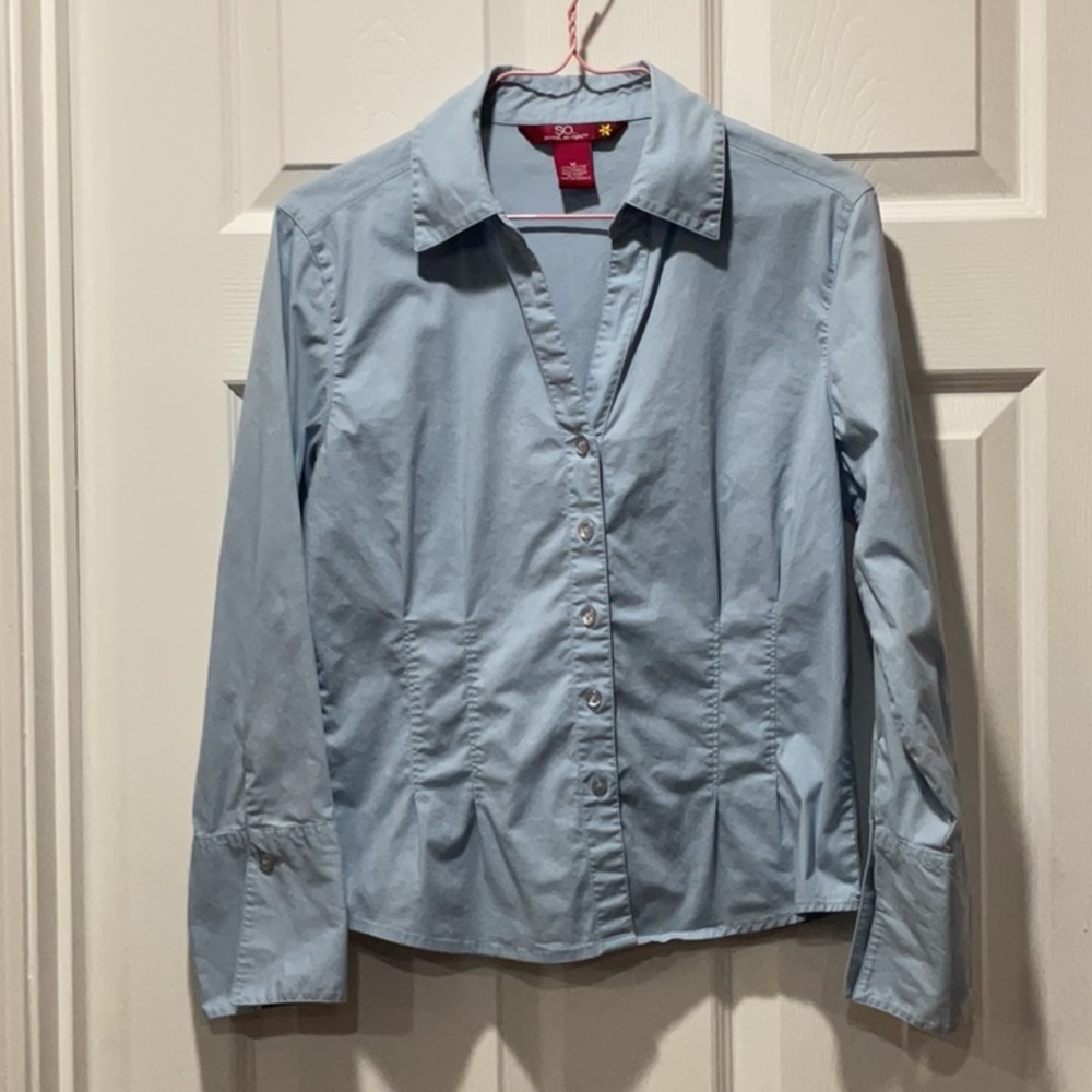 Fitted light blue button down collared shirt with fold up sleeve cuffs